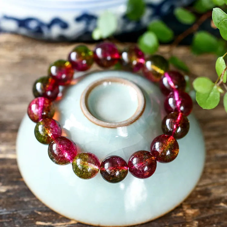 Handmade watermelon red crystal bracelet for women, shown in a casual style with pastoral elements.