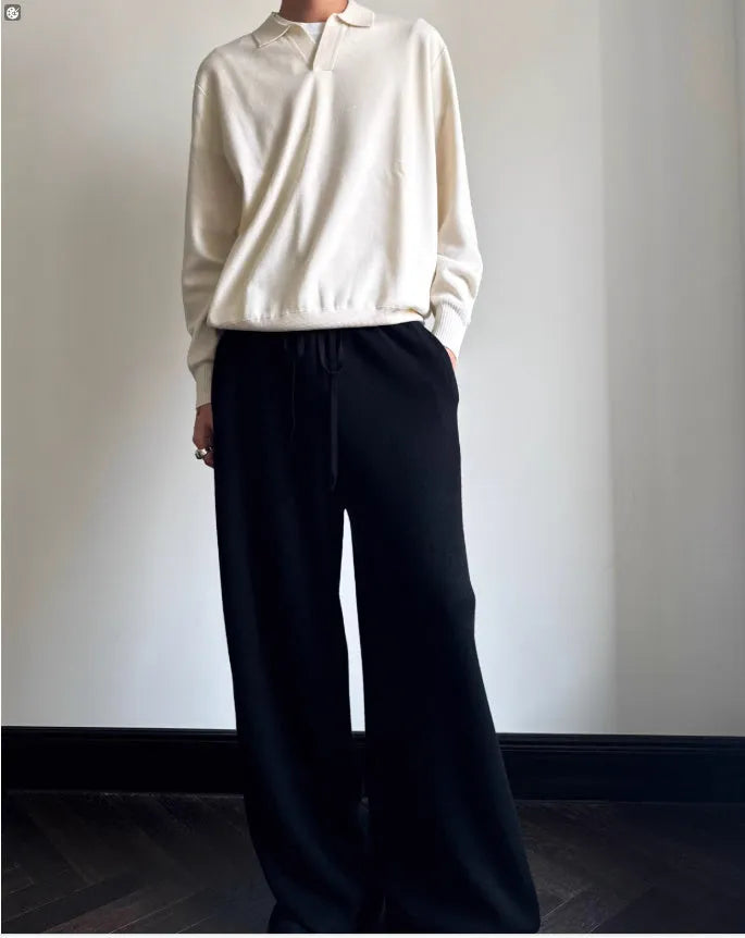 Men's loose-fit lapel-collar wool sweater in navy blue, laid flat showing front design.