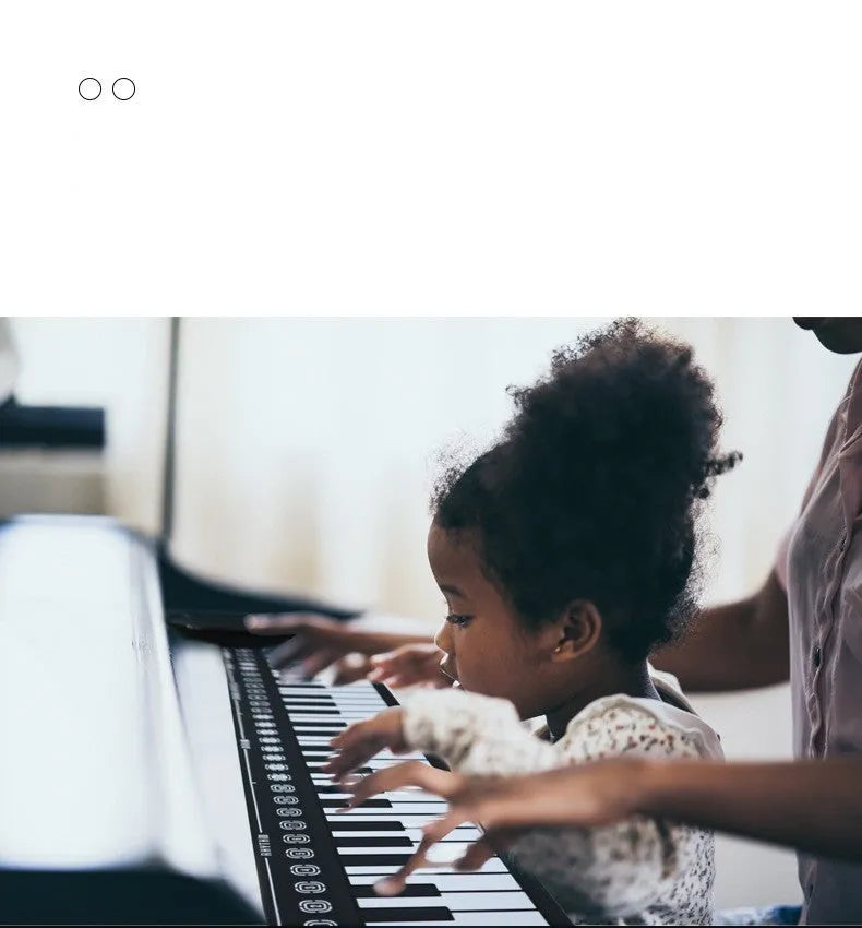 49 key roll up electronic keyboard in glossy black showing flexible silicone piano keys and portable folding design