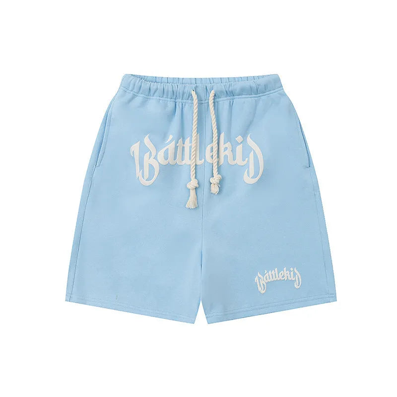A pair of loose-fit black hip hop shorts made from cotton blend fabric on a mannequin.