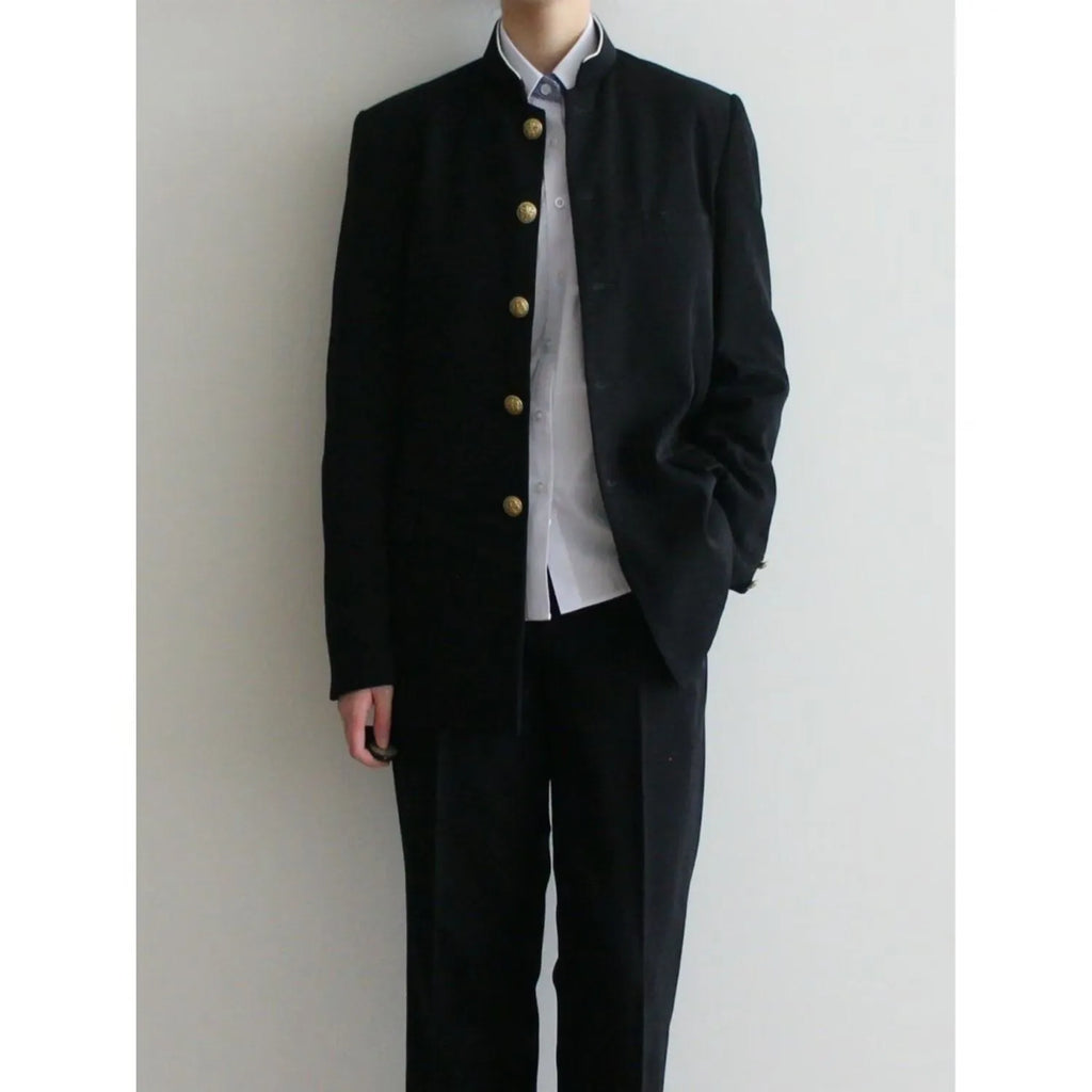 Solid black Korean style casual suit blazer with long sleeves, loose fit, and patch pockets on model