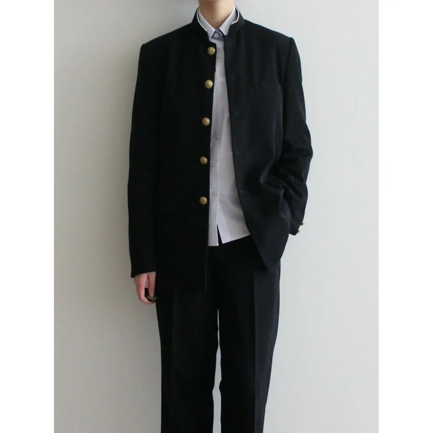 Solid black Korean style casual suit blazer with long sleeves, loose fit, and patch pockets on model