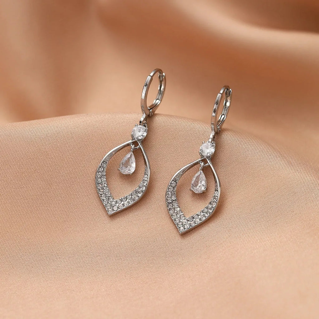 Gold and silver water drop tassel earrings with zircon stones on a copper base.