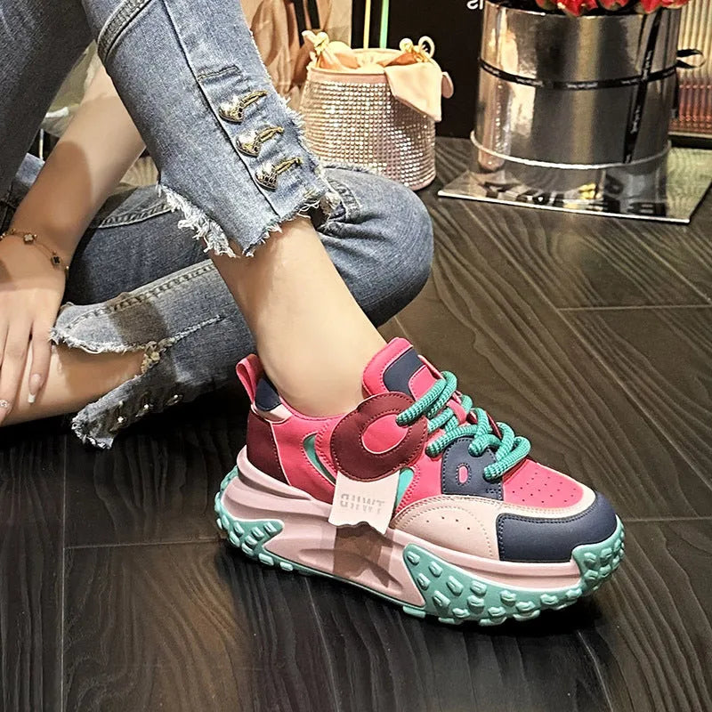 A pair of thick-soled leather casual shoes with a wedge heel and round toe in a lace-up design.