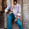 Lilac plaid print loose fit long sleeve sweater with ribbed trim on a hanger.