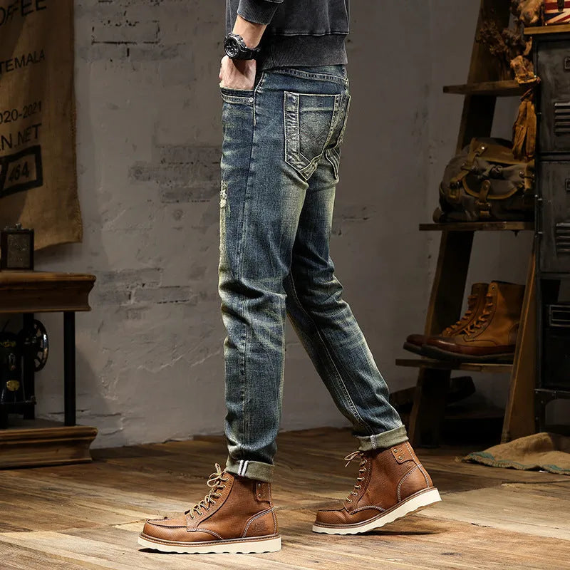 Men's skinny fit retro blue jeans with a zip fly on a plain background