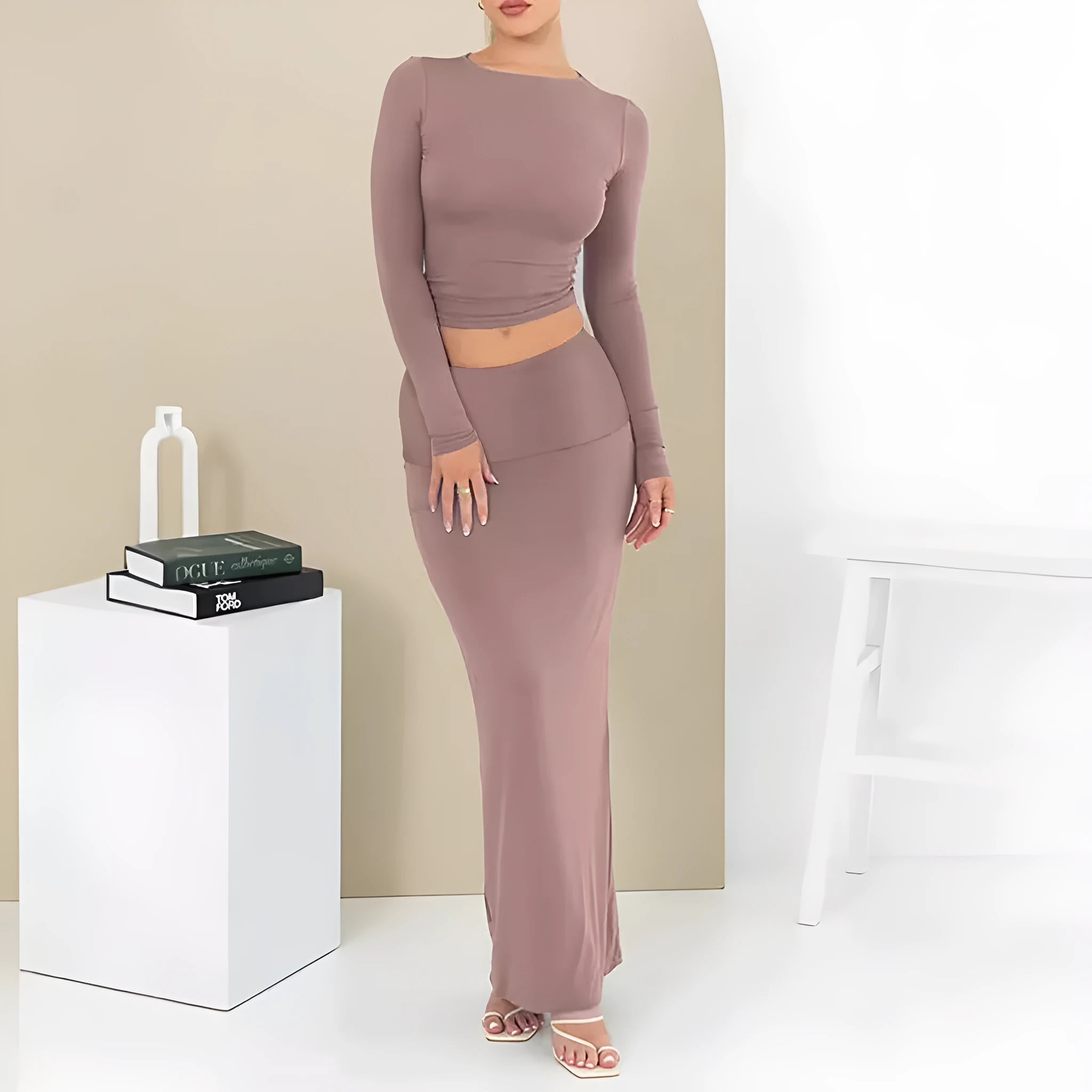 Women's black slim fit polyester two-piece suit with three-quarter sleeve top and long skirt.