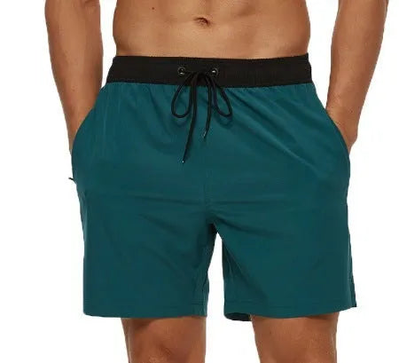 Men's blue drawstring athletic shorts with a zipper pocket and stitching detail on the waistband