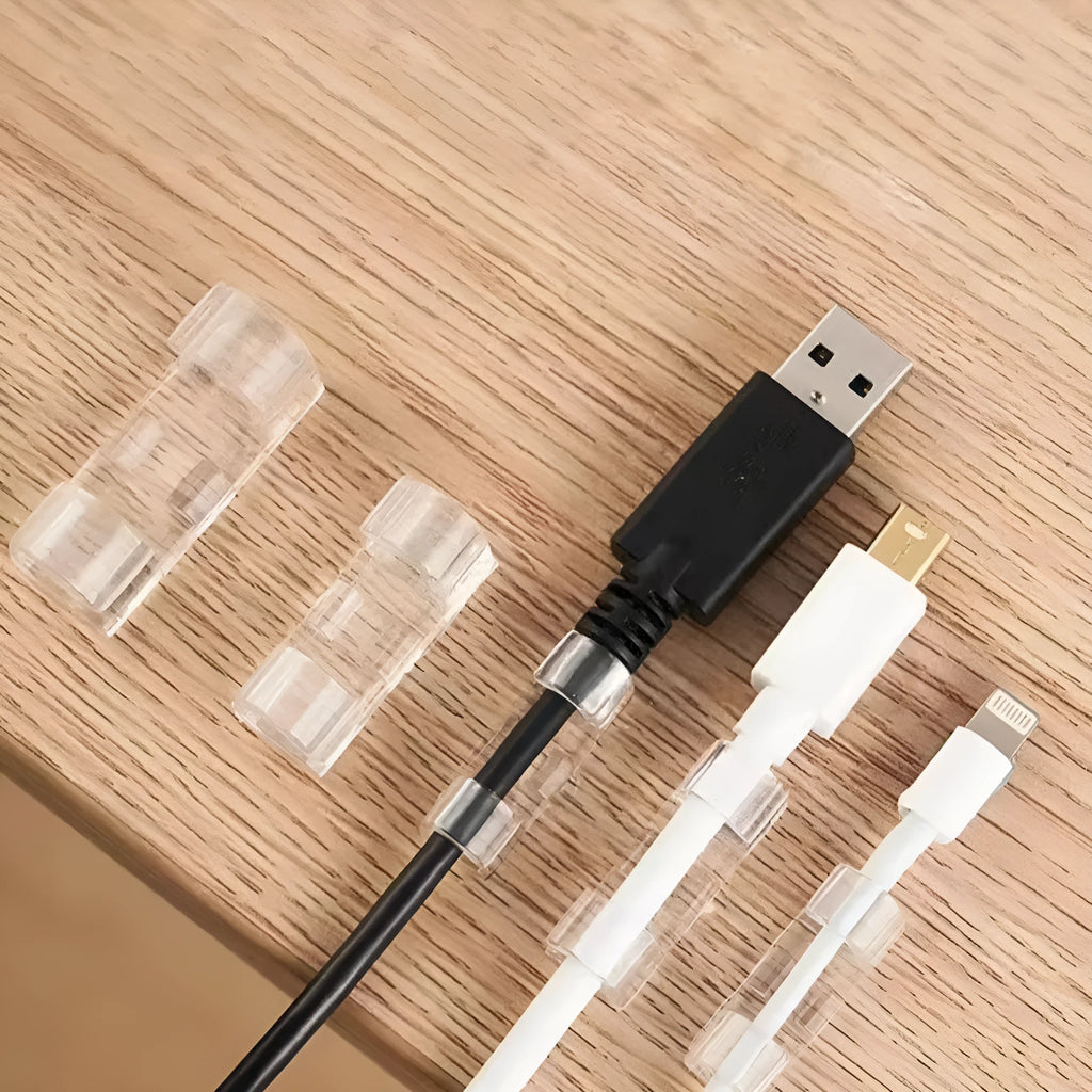 Transparent self-adhesive plastic snap clips for cable management on a white background.