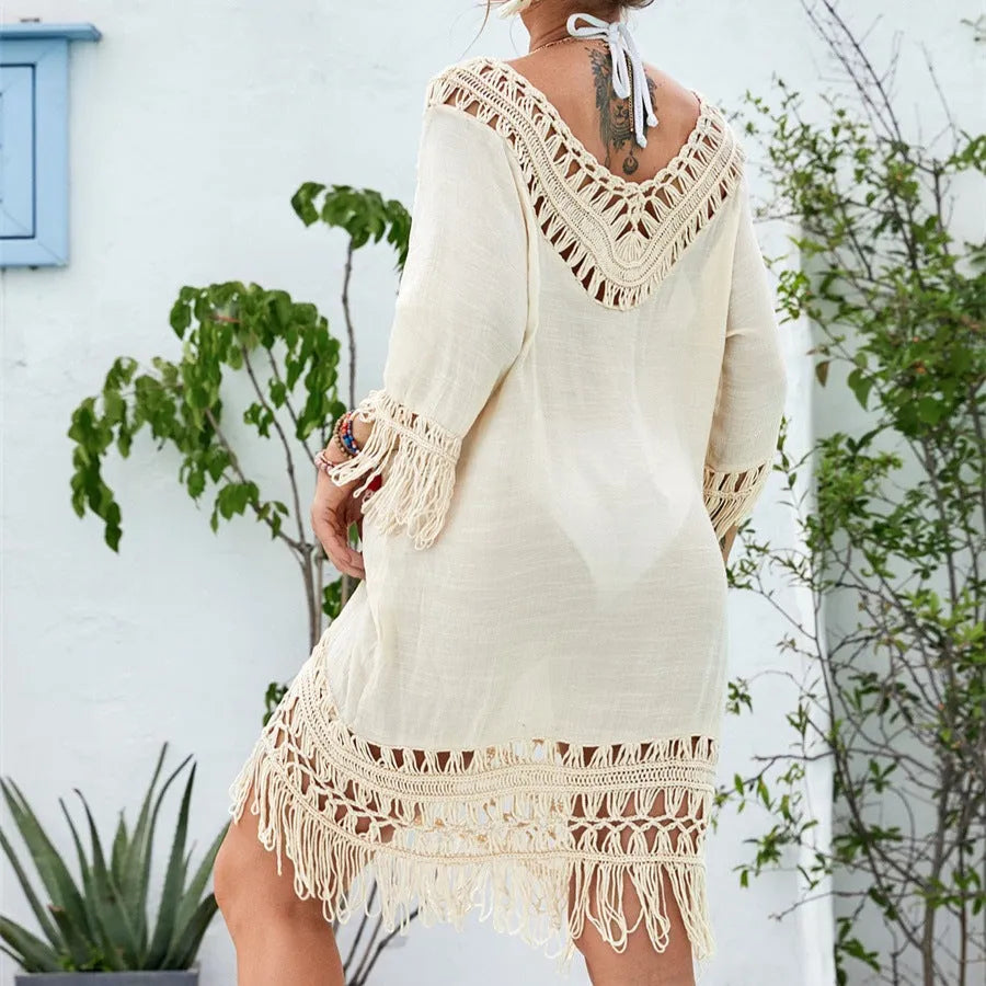 Apricot coloured women's crocheted patchwork dress with half sleeves on a hanger