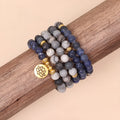 Close-up of a blue patterned network stone bead multi layer alloy bracelet on a wrist
