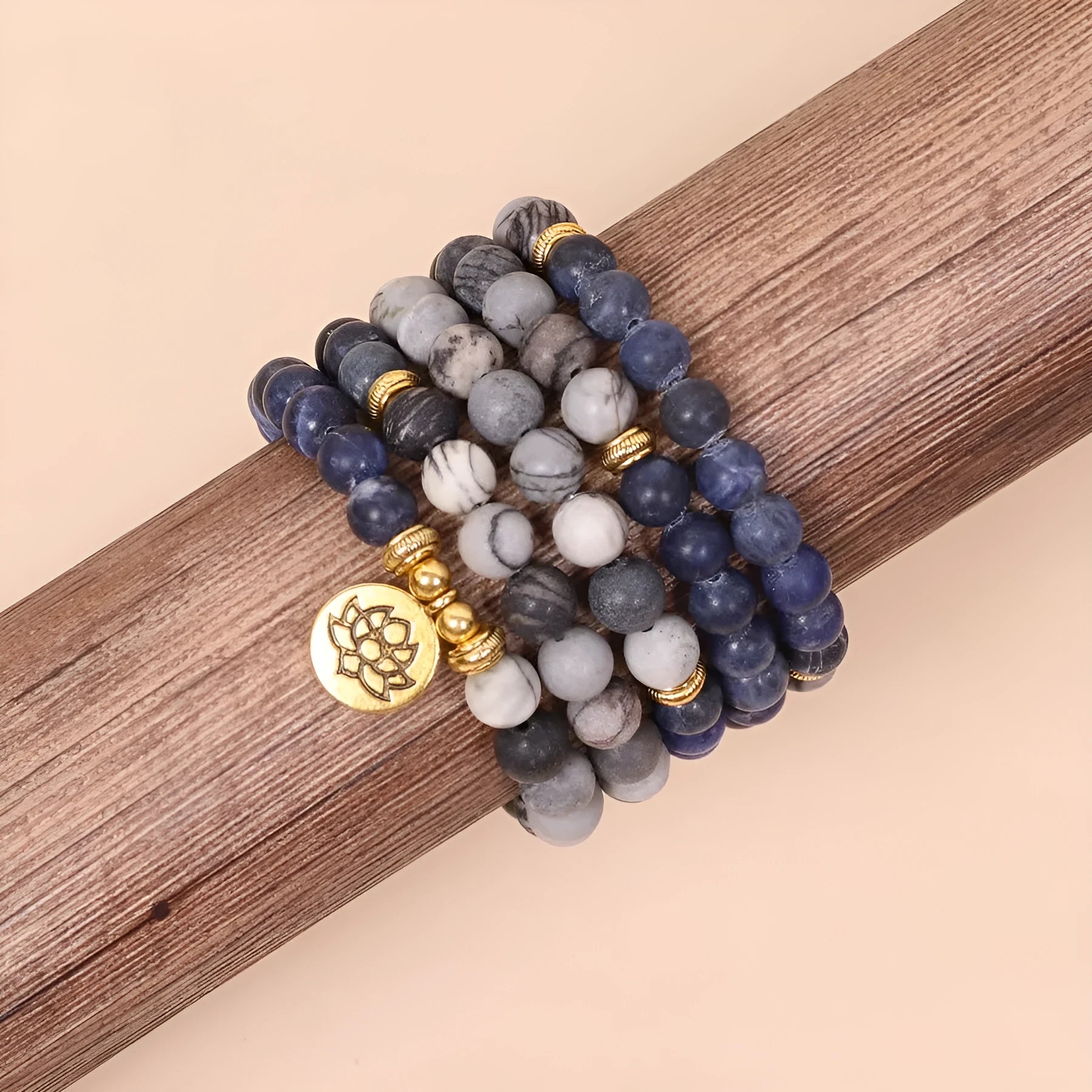 Close-up of a blue patterned network stone bead multi layer alloy bracelet on a wrist