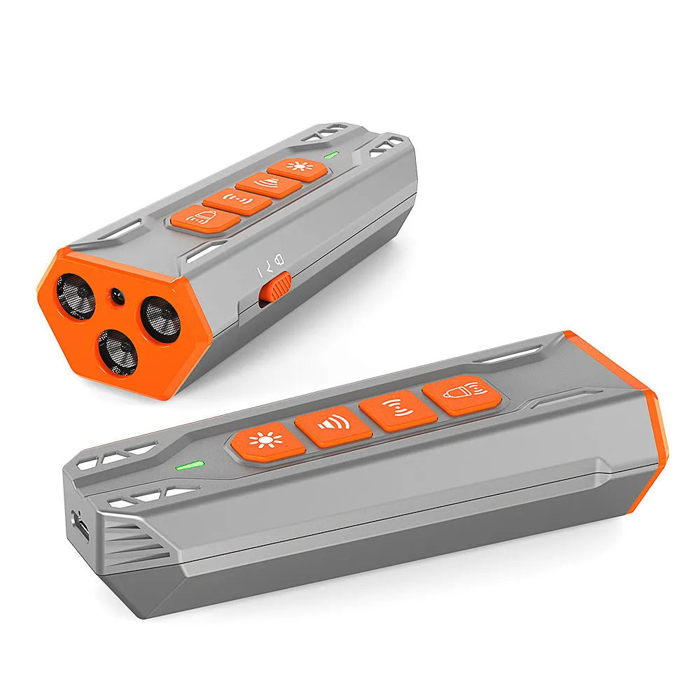 Grey and orange coloured three-head ultrasonic dog trainer with remote control on a table.