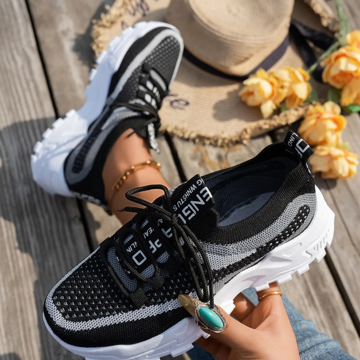 Women's Flyknit mesh lace-up sneakers in grey and white colourway