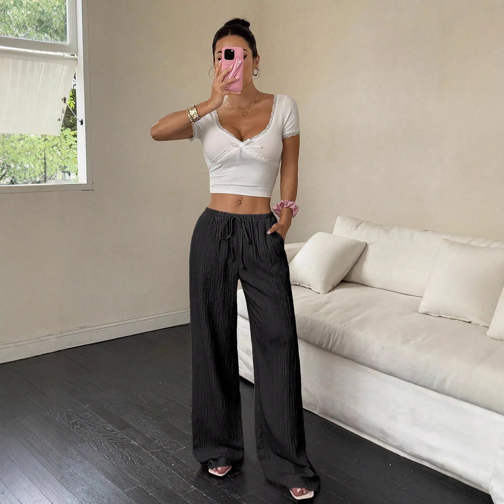 Women's black wide-leg trousers with lace-up waist detail on mid-waist