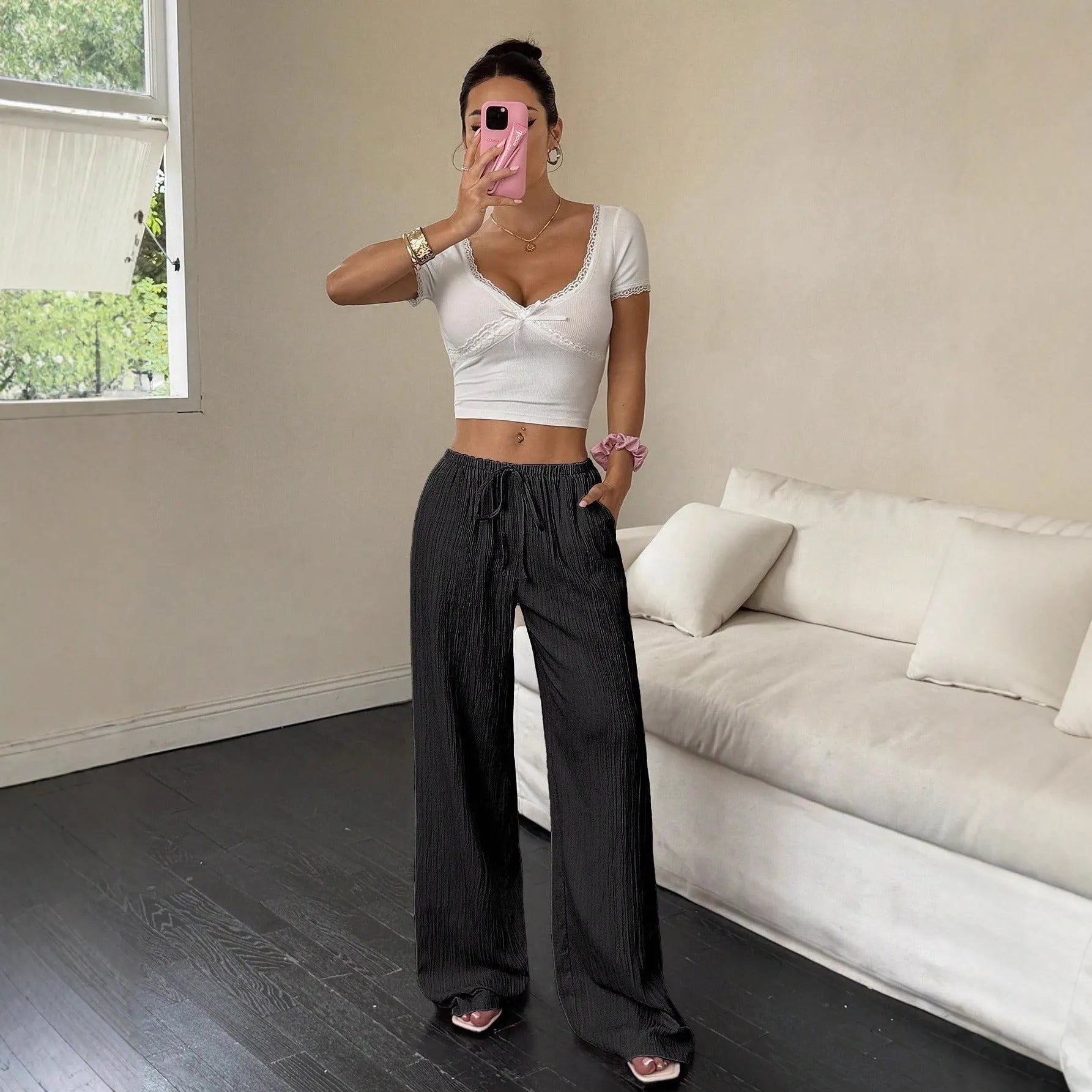Women's black wide-leg trousers with lace-up waist detail on mid-waist