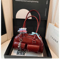 Retro brown PU leather women's pillow handbag with a flap and double shoulder strap on a neutral background.
