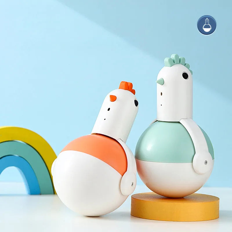 Green or orange electric chicken-shaped cat toy with laser and sound features on a flat surface.