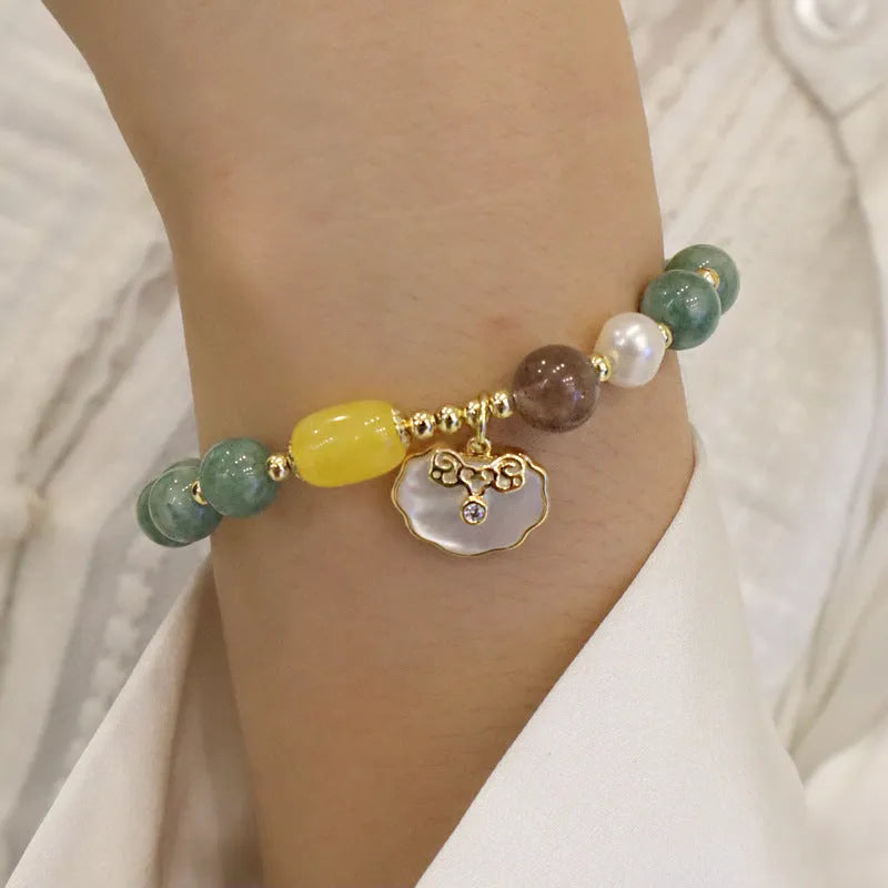 Green jade bracelet with carved shell charm and adjustable silver-tone clasp