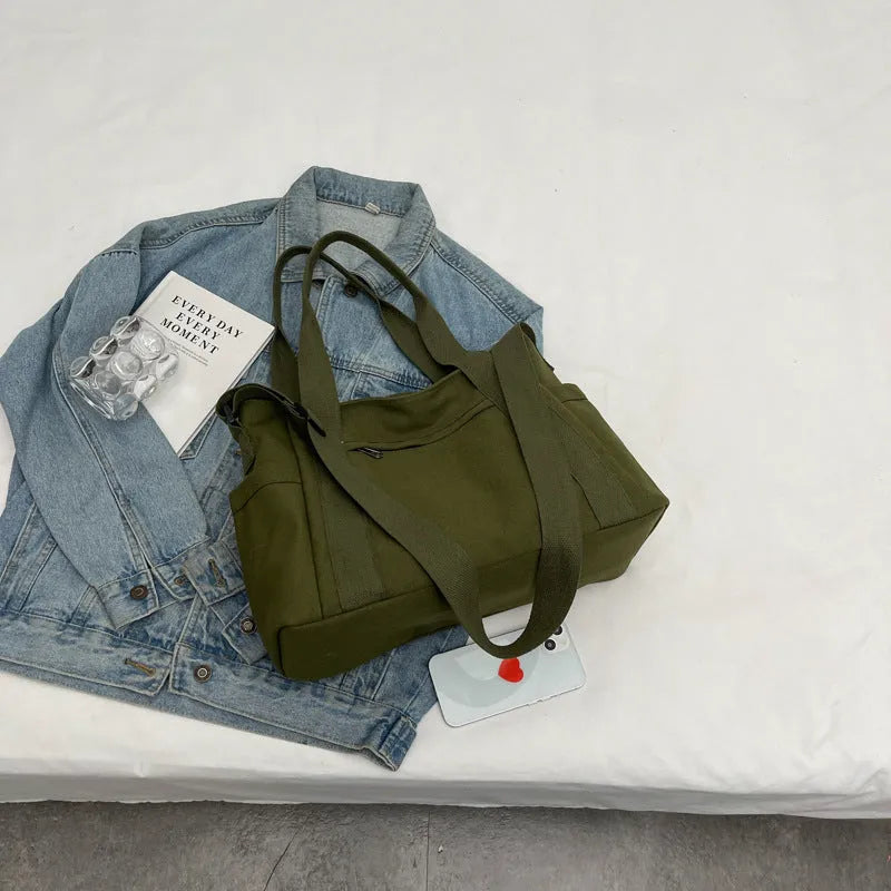 Large polyester canvas shoulder tote bag in solid colour with outer pocket and shoulder strap