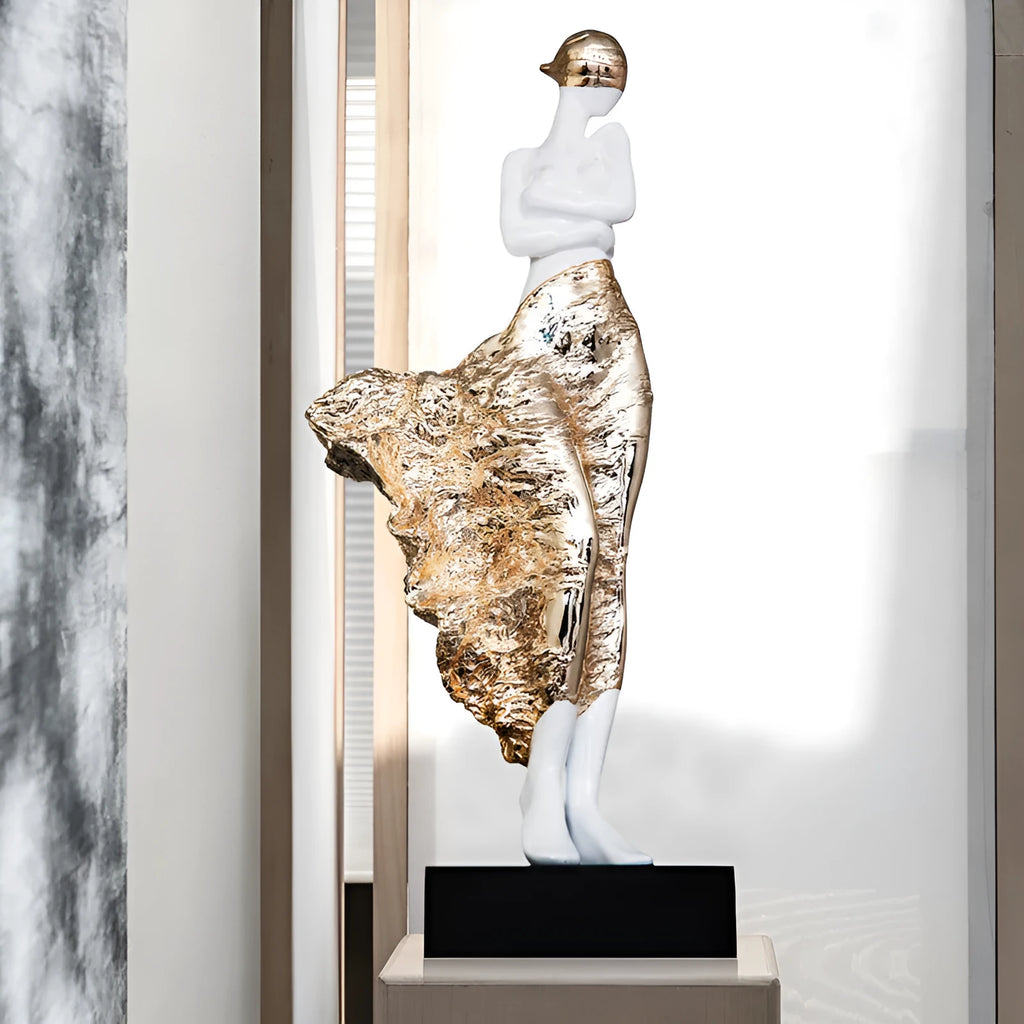 Tall metallic character sculpture ornament on a neutral background