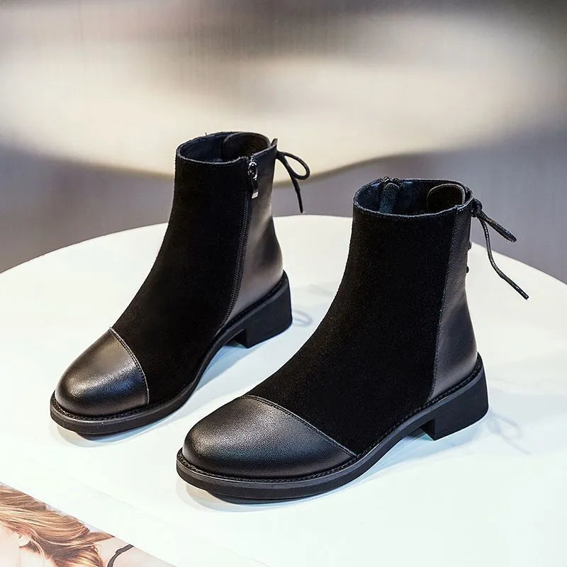 Women's black knee-high Martin boots with side zip, round toe, bow detail, and non-slip rubber sole