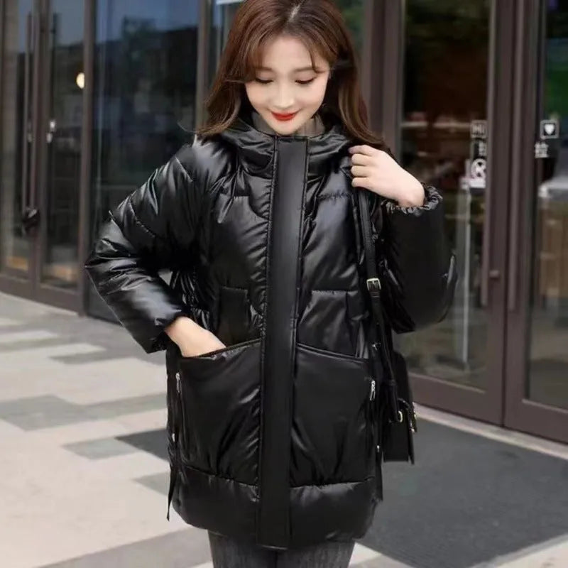 Women's loose fit thick hooded down cotton jacket in black, shown with long sleeves and a front zip.
