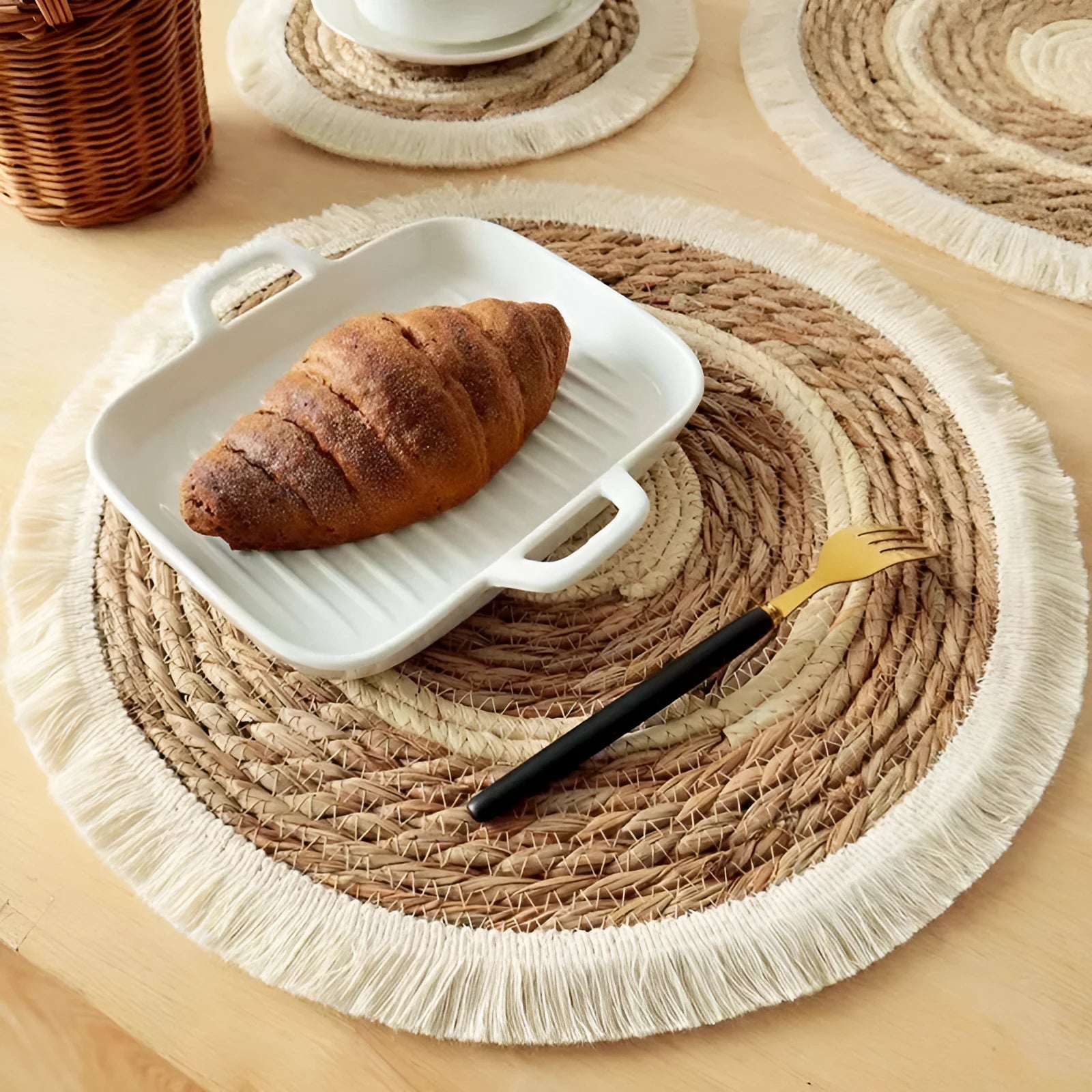 Round papyrus straw placemat with corn rope tassel detailing in modern simplicity style