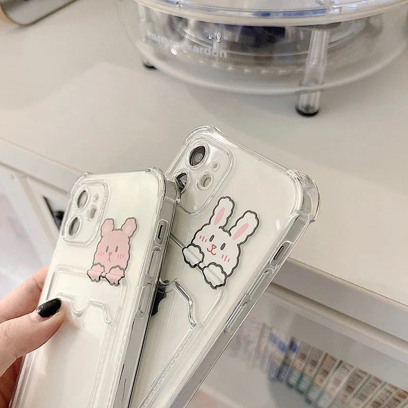 Transparent cartoon-themed iPhone case with a card slot, shown on an iPhone.