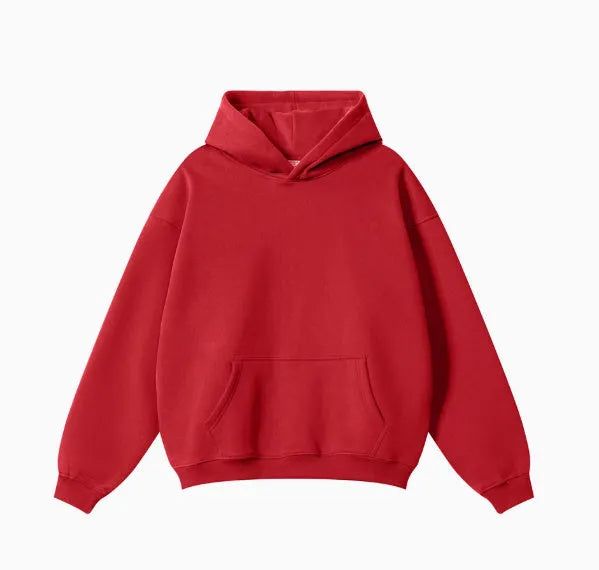 Man wearing a loose-fit cotton terry hooded sweater with drop-shoulder sleeves in a solid colour.