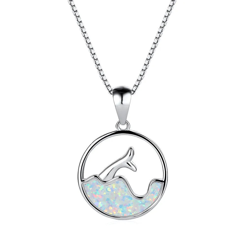 White gold electroplated necklace with a round geometric fishtail pendant in blue opal colour.