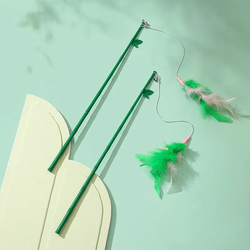 Green interactive cat feather wand toy with bells and synthetic feather attachments