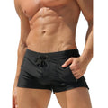 Men's black high-waist swimming trunks with a lace-up front and briefs style.