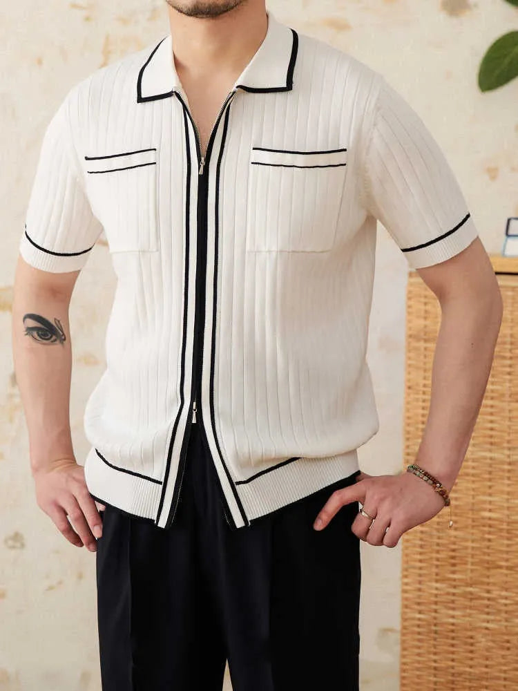 Man wearing a slim black polo shirt with a lapel collar and short sleeves.