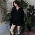 Women's creamy-white cable knit suit set with long sleeve jumper and elastic waist shorts.