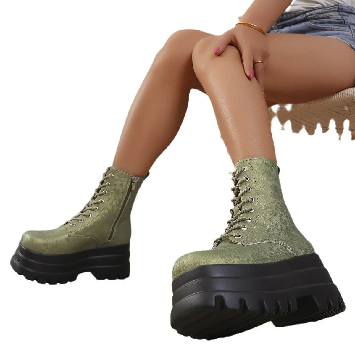 Women's black retro platform Martin boots with patchwork toe and side zip.