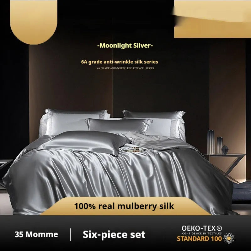 Silk four-piece quilt cover set in a solid colour, shown in a bedroom setting on a bed.