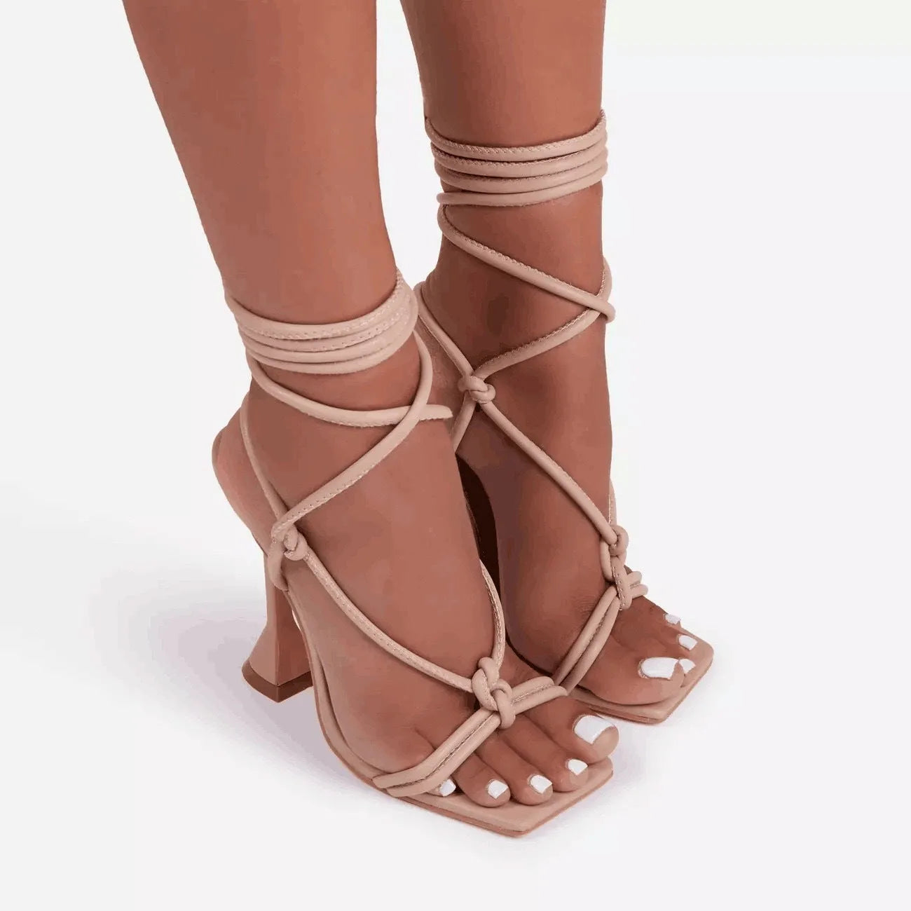 Women's high heel strappy sandals in black with square toe, stiletto heel, and cross-strap upper