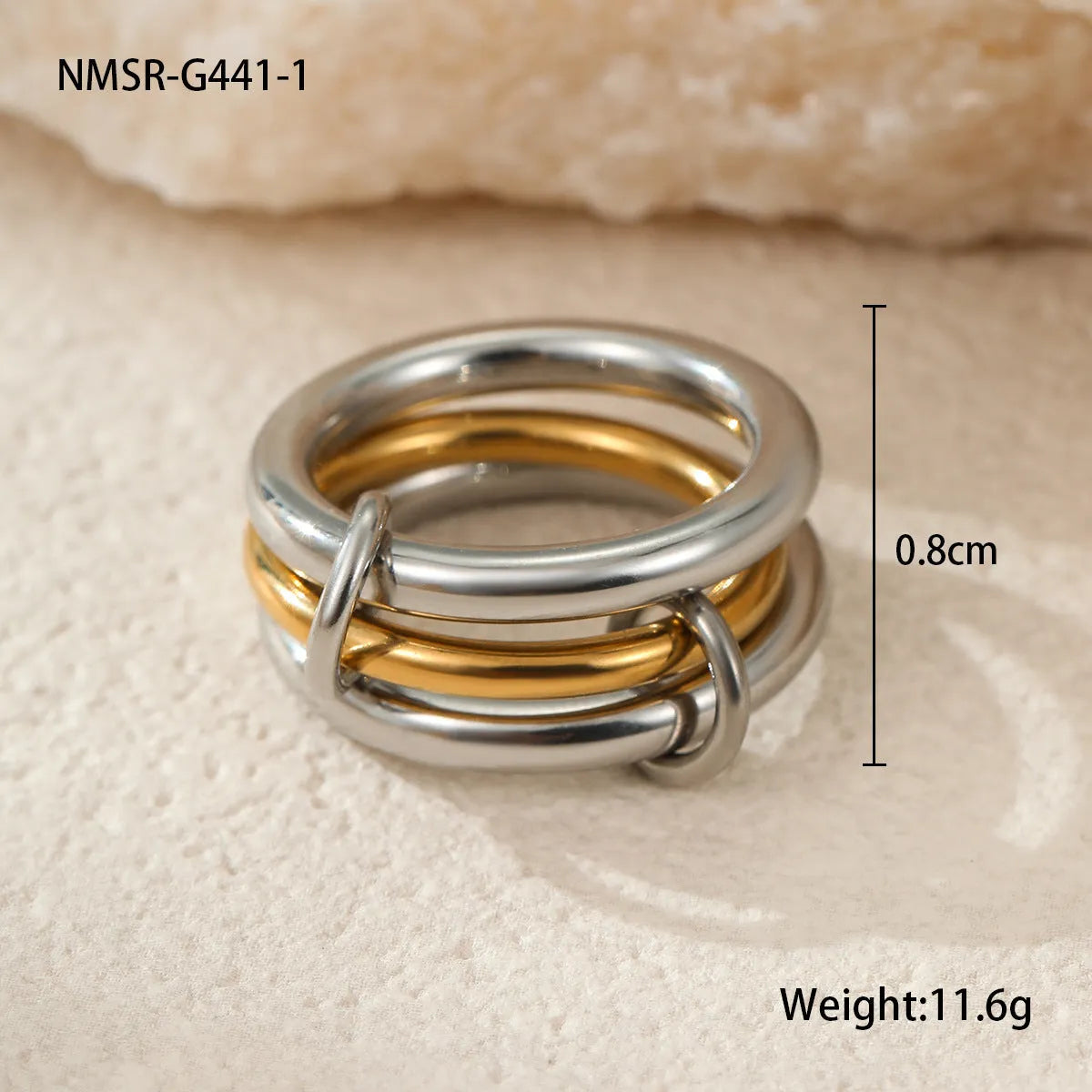 Stacked gold plated stainless steel ring set showing exaggerated design on a model's hand.