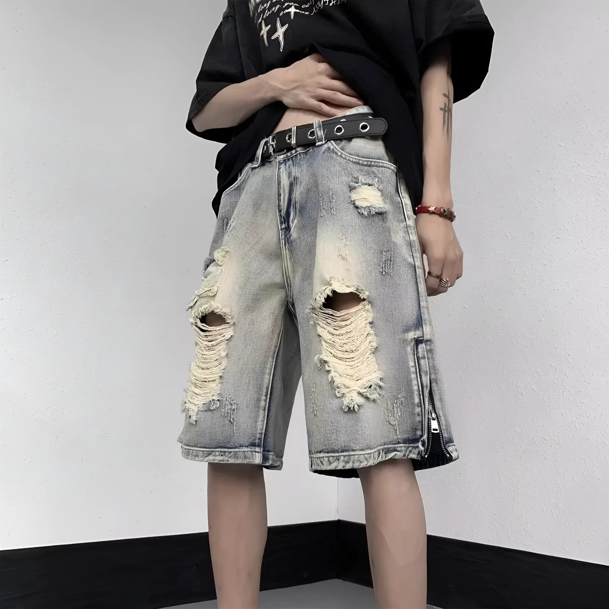 Blue retro-style denim shorts with a wide-leg loose fit and tattered details on a neutral background.