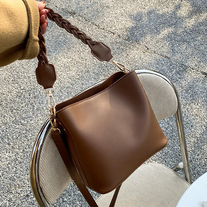 Retro woven PU leather crossbody bucket bag in khaki colour showing underarm design and textured surface