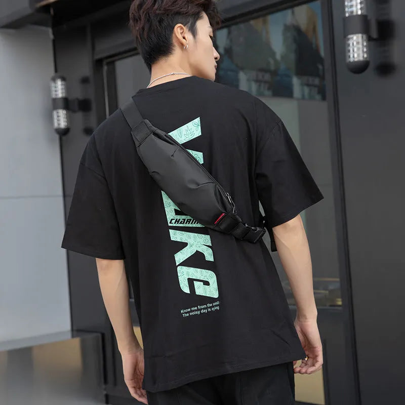 Black oxford cloth men's waist pack with crossbody strap, showing phone and ID pockets.