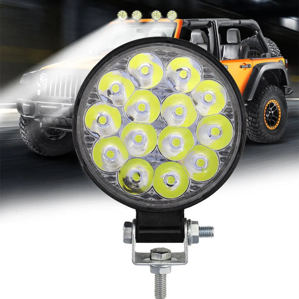 Mini round aluminium LED work light with white light, 42W power and IP67 waterproof rating.