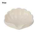White or pink shell-shaped plastic soap dish for bathroom countertop.