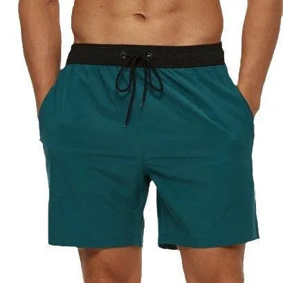 Men's blue drawstring athletic shorts with a zipper pocket and stitching detail on the waistband