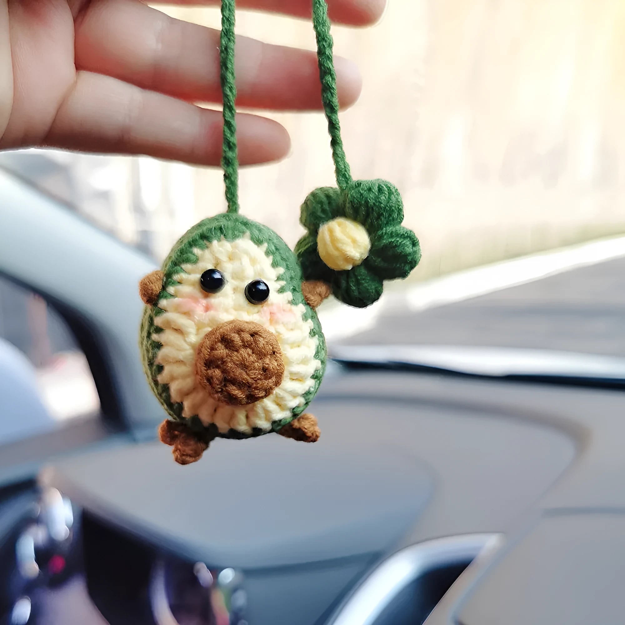 Handmade crocheted avocado car pendant with rainbow flower design in wool material