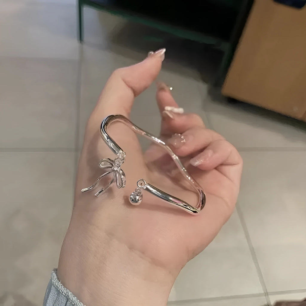 Silver bow adjustable girlfriends bracelet with bell opening clasp and sliding charm
