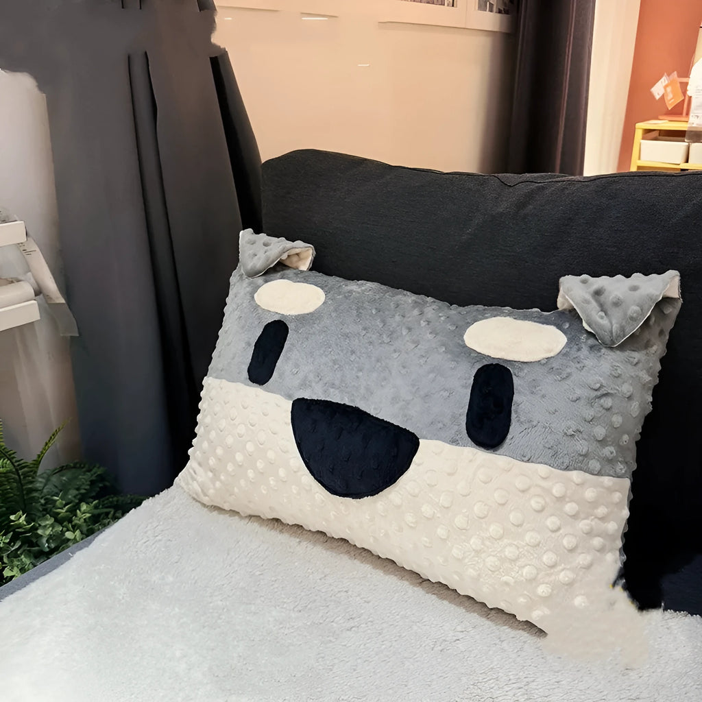 Grey or white West Highland puppy shaped pillow on a sofa, 50cm long.