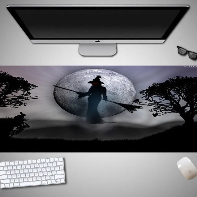 Large Halloween-themed computer mouse pad with graphic design on a desk