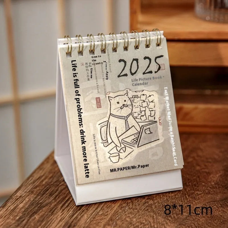 Mini 2025 desk calendar in a simple modern design on a wooden desk